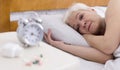 Upset senior ledy with sleep disorder lying in bed