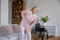 Upset senior woman suffering from radiculitis back pain