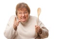 Upset Senior Woman with The Wooden Spoon