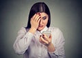 Upset shocked serious woman looking at her mobile phone. Royalty Free Stock Photo