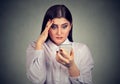 Upset shocked serious woman looking at her mobile phone. Royalty Free Stock Photo