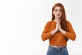 Upset silly cute redhead girlfriend grimacing upset hold palms together pray begging favour asking pleading help