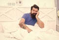 upset sleepy man with beard has male health problems in bed, morning erection problem Royalty Free Stock Photo