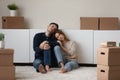 Upset spouses leave house sit on floor near cardboard boxes
