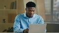 Upset stressed African American man ethnic sad businessman working laptop in home office frustrated angry worker Royalty Free Stock Photo