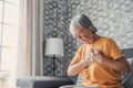 Upset stressed mature middle aged woman feeling pain ache touching chest having heart attack, sad worried senior older lady Royalty Free Stock Photo