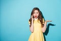 Upset surprised girl in dress talking on mobile phone Royalty Free Stock Photo