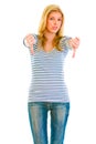 Upset teen girl showing thumbs down gesture Royalty Free Stock Photo