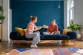 Upset teen girl sitting on sofa listening angry mother scolding her for bad school grades Royalty Free Stock Photo