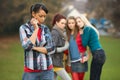 Upset Teenage Girl With Friends Gossiping