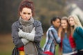 Upset Teenage Girl With Friends Gossiping