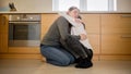 Upset teenage girl hugging and embracing her mother sitting on kitchen floor. Mental problems and depression of teens Royalty Free Stock Photo