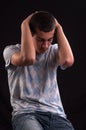 Upset teenager with head in hands wincing from stress, anguish o Royalty Free Stock Photo