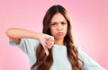 Upset, thumbs down and portrait of a female in a studio with a sad, moody or disappointed face. Loser, unhappy and young