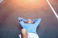Upset tired athlete lying on the track on the street after failure Royalty Free Stock Photo
