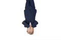 Upset or tired boy in school uniform covered his face with his hands. Schoolboy upside down. Portrait is isolated on white