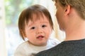 Upset toddler boy crying on his father`s shoulder Royalty Free Stock Photo