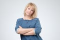 Upset unsatisfied blonde woman standing with arms folded