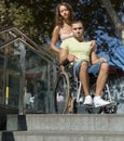 Upset wife with man in wheelchair on stairs Royalty Free Stock Photo