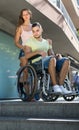 Upset wife with man in wheelchair on stairs Royalty Free Stock Photo