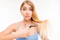 Upset woman cutting her split ends Royalty Free Stock Photo