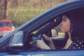 Upset woman driver inside her car in a heavy traffic Royalty Free Stock Photo