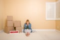 Upset Woman on Floor, Boxes and Foreclosure Sign