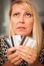 Upset Woman Glaring At Her Many Credit Cards