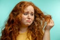 Upset and woman with her damaged dry hair face expression blue background Royalty Free Stock Photo