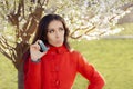 Upset Woman with Inhaler in Spring Blooming Decor Royalty Free Stock Photo