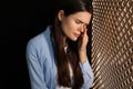 Upset woman listening to priest during confession in booth Royalty Free Stock Photo