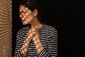 Upset woman listening to priest during confession near wooden partition in booth, space for text Royalty Free Stock Photo