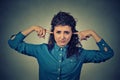 Upset woman plugging ears with fingers doesn't want to listen