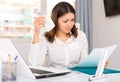 Upset woman reading documents and holding napkin at the office Royalty Free Stock Photo