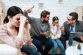 Woman clasped her hands while sitting in office.