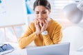 Upset woman trying not to cry while having toothache at work Royalty Free Stock Photo