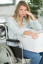 upset woman in wheelchair doing laundry