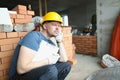 Upset worker sit surrounded with construction site mess with paper Royalty Free Stock Photo