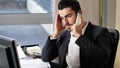 Upset, worried business on phone in office