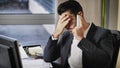 Upset, worried business on phone in office