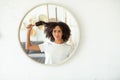 Upset young african american female pulls comb out of tangled curly hair feels pain