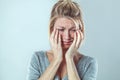 Upset young blond woman crying with big tears expressing sorrow Royalty Free Stock Photo