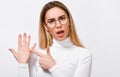 Upset young blonde woman wearing white blouse and round trendy transparent glasses, showing engagement ring on her finger, posing Royalty Free Stock Photo