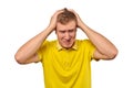 Upset young male in yellow T-shirt clutched at head, forgetful man, isolated on white background Royalty Free Stock Photo