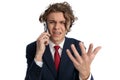 Upset young man talking on the phone and asking for explanations Royalty Free Stock Photo