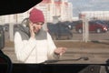 Upset young woman after a car accident calling on the phone Royalty Free Stock Photo