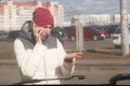 Upset young woman after a car accident calling on the phone Royalty Free Stock Photo