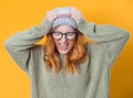 Upset young woman with hands on head and tearing hair out while looking to camera, isolated on white background Royalty Free Stock Photo