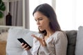 Upset young woman having problem with mobile phone, reading bad news Royalty Free Stock Photo