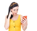 Upset young woman looking to spoiled mobile phone, isolated on white background Royalty Free Stock Photo